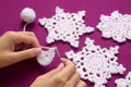 Woman knits crochet Christmas decoration Ã¢â¬â snowflakes